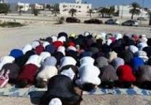 Bahraini people say prayers in mosque debris