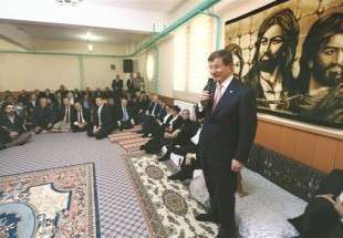 Prime Minister Davutoğlu speaks in front of a poster of Caliph Ali during his visit to a cemevi, an Alevi house of worship, in the predominantly Alevi-populated eastern city of Tunceli.