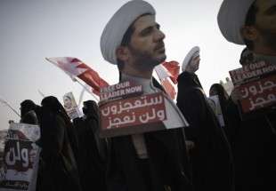 Bahraini protesters march during a demonstration against the arrest of Sheikh Ali Salman (on the posters), head of the opposition movement al-Wefaq, in Salman