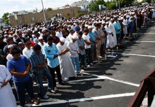 Mourners demand end to hate crimes at slain imam’s funeral