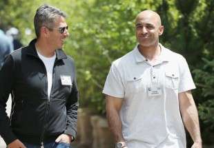 In this July 9, 2015 photo, Casey Wasserman (L), the chief executive officer of Wasserman Media Group, chats with Yousef Al-Otaiba, United Arab Emirates