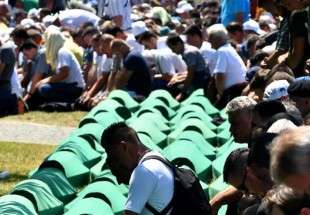 Bosnian Muslims, survivors of the 1995 Srebrenica massacre, as well as other visitors, pray near body caskets of their relatives, laid out at a memorial cemetery in the village of Potocari, near the eastern Bosnian town of Srebrenica, July 11, 2017. (Photo by AFP)