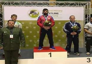 Iranian freestyle wrestler Alireza Karimi (in red jacket) poses for a photograph after finishing first in the 86-kilogram weight category of the 32nd edition of the World Military Wrestling Championship in Klaipeda, Lithuania