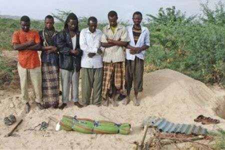 Men from southern Somalia offer funeral prayers for a dead child in Mogadishu on September 10, 2011.