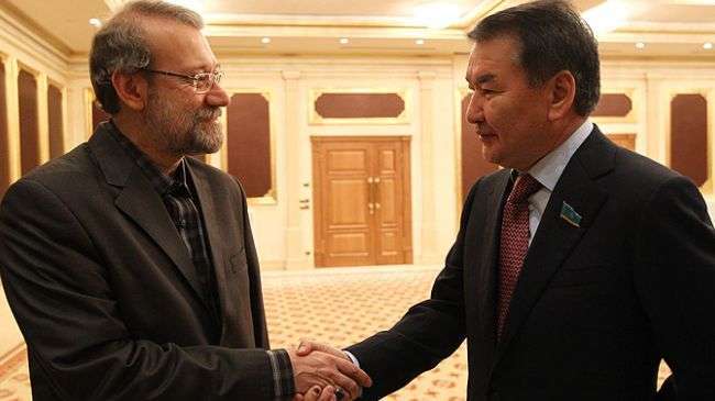 Iranian Majlis Speaker Ali Larijani (L) shakes hands with Chairman of Kazakhstan’s Senate Kairat Mami in Ashgabat on September 6, 2013.