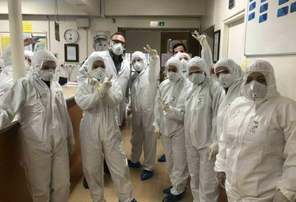 Iranian doctors and nurses showing victory sign amid coronavirus epidemic.