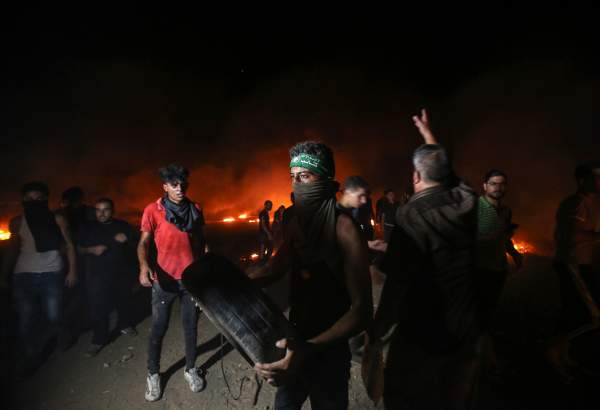 Palestinian protesters burn tires near Israeli border in Gaza Strip