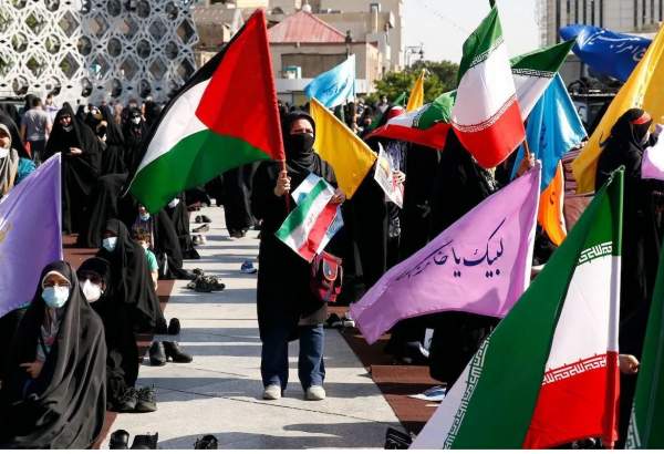 Iranian women wave Palestinian and national flags during a march to condemn the ongoing Israeli air strikes on the Gaza Strip, in the capital Tehran