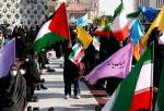 Iranian women wave Palestinian and national flags during a march to condemn the ongoing Israeli air strikes on the Gaza Strip, in the capital Tehran