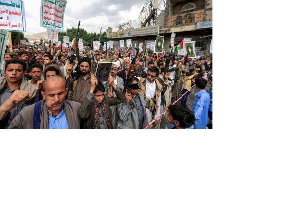 People march with copies of the Quran during a demonstration in Yemen