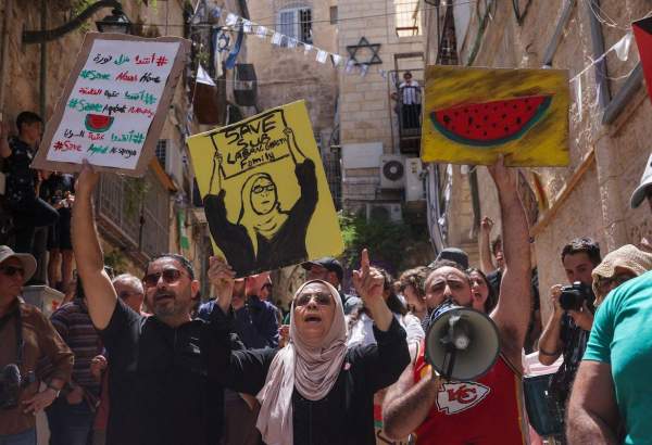 Nora Sub Laban (C) stands alongside Palestinians and Israeli left-wing activists protesting the planned eviction of her family from their home in the ancient Muslim Quarter in Jerusalem’s old city to make way for Jewish settlers, on June 16, 2023. [AHMAD GHARABLI/AFP via Getty Images]