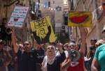 Nora Sub Laban (C) stands alongside Palestinians and Israeli left-wing activists protesting the planned eviction of her family from their home in the ancient Muslim Quarter in Jerusalem’s old city to make way for Jewish settlers, on June 16, 2023. [AHMAD GHARABLI/AFP via Getty Images]