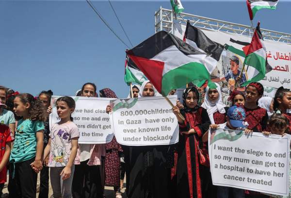 A group of Palestinian children carrying banners gather to protest Israel’s policies and demand an end to the blockade on the Gaza Strip since 2006 in Gaza City, Gaza on July 16, 2023 [Mustafa Hassona/Anadolu Agency]