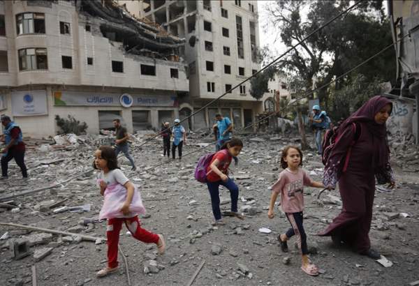 Residents move away for safer spots amid destroyed buildings and debris around the Palestinian Telecommunications Company, which was targeted, after Israeli airstrikes in Gaza Strip on October 10, 2023. ( Ashraf Amra - Anadolu Agency )